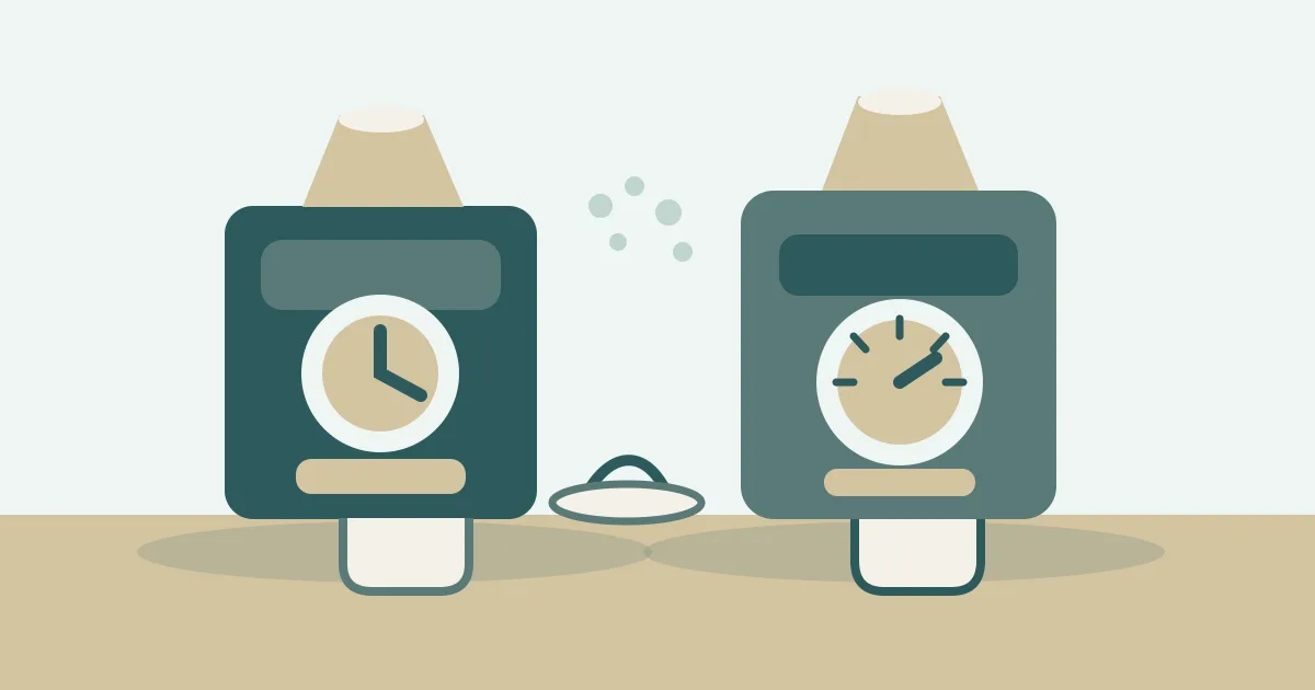 Two single dose espresso grinders with dosing cups on a kitchen counter